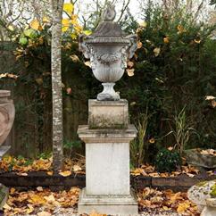 A Pair of Ramshead and Grapevine Decorated Urns